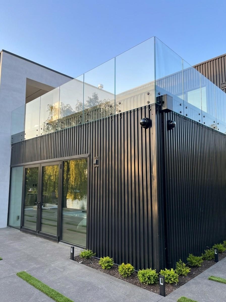 exterior balcony glass rails on matte black stand-offs installed by igo green enterprises inc.