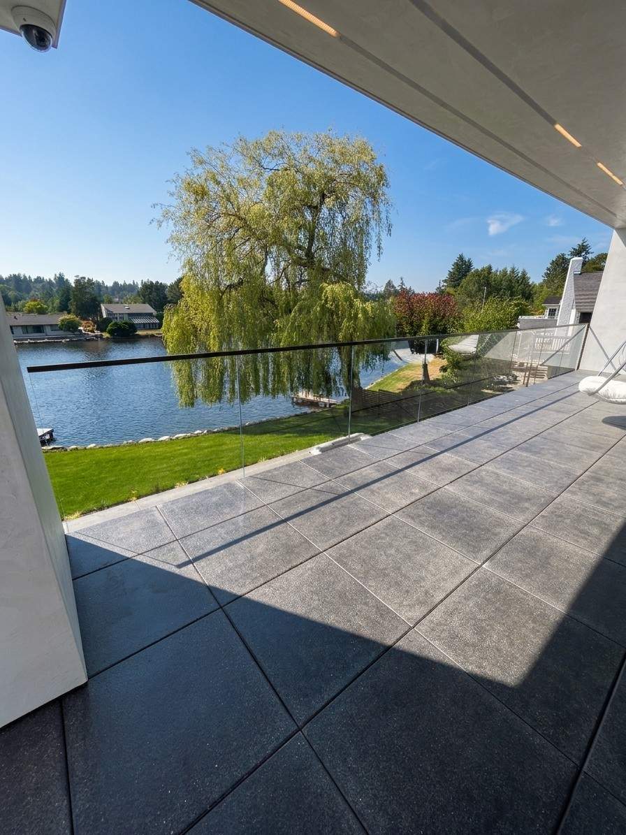 exterior center balcony glass rails on matte black stand-offs installed by igo green enterprises inc.